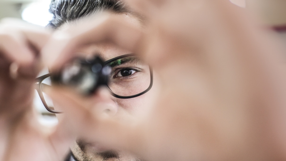 person inspecting device Worker inspecting a microchip device closeup.